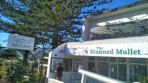 The Stunned Mullet metal awning sign made from aluminium composite material (ACM) to attract street traffic, and printed vinyl graphics sized to fit a painted panels to advertise specials.