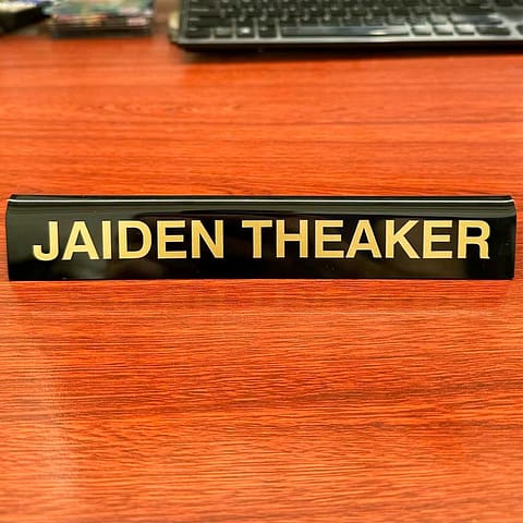 Desk name plates - cut vinyl (antique gold) applied to a blank acrylic name plate.