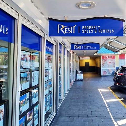 Building Signage for Rest Property - awning signs for the facade, frosted glass graphics for office privacy and print and cut vinyl decals for external glazing.