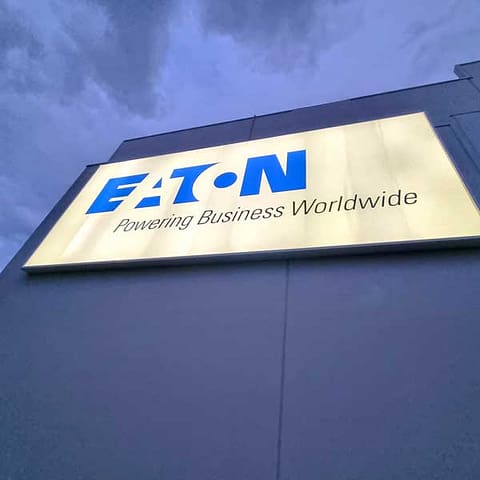 Illuminated sign with flex face banner for Eaton (closeup evening sign)