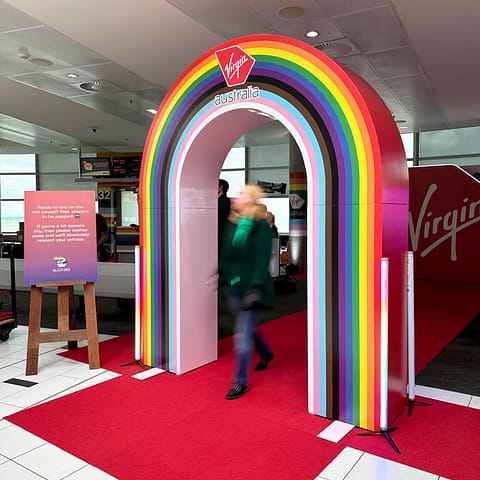 Printed vinyl graphics installed over a wooden archway provide an impressive entrance for any event